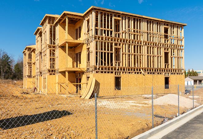 a construction site enclosed by temporary chain link fences, ensuring safety for workers and pedestrians in McQueeney, TX